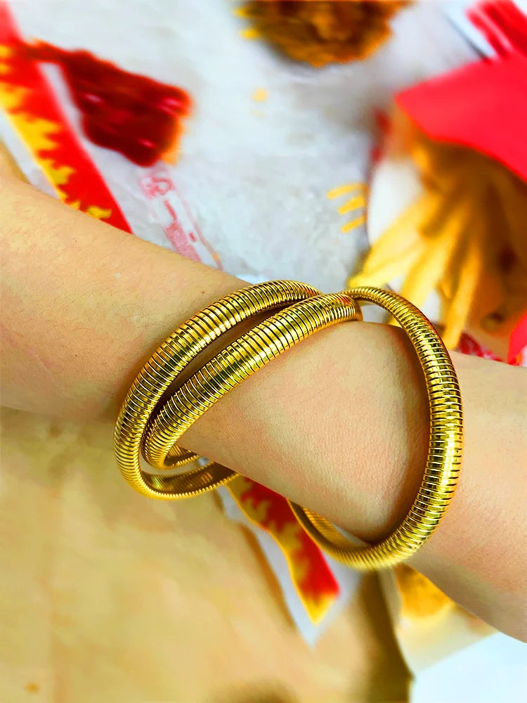 Fairies Whisper The Feast Collection Statue of Liberty Bracelet, gold coiled metal spring-inspired jewelry