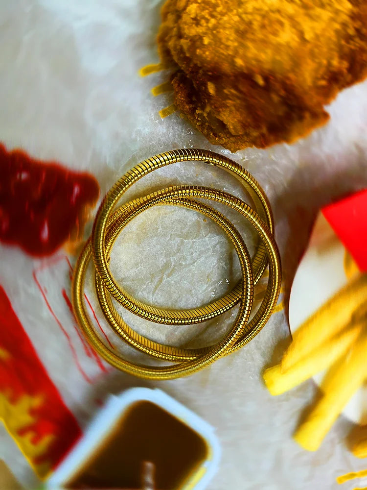 Fairies Whisper Cleopatra Bracelet close-up, textured gold spiral coil metal bracelet