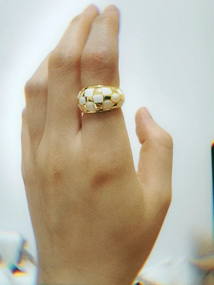 Fairies Whisper Shakespeare gold and white checkerboard ring worn on hand, vintage dramatic jewelry