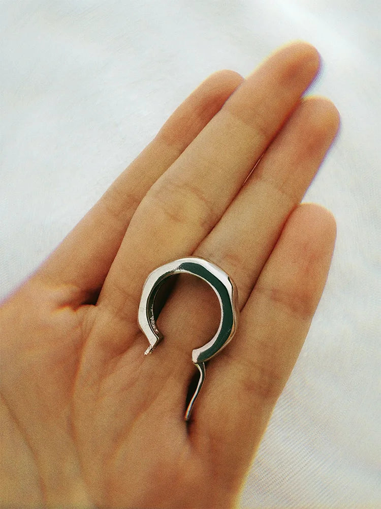 Fairies Whisper silver bubble polygon wave earrings, medium small hoops, shown on hand about one and a half finger width.