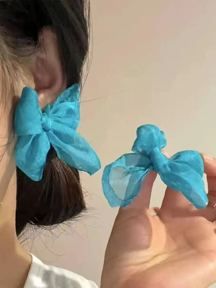 Braided yarn with blue bow earrings