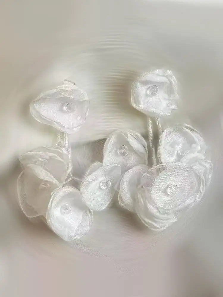 Boucles d'oreilles à clip en gaze tissée, motif étamines vibrantes