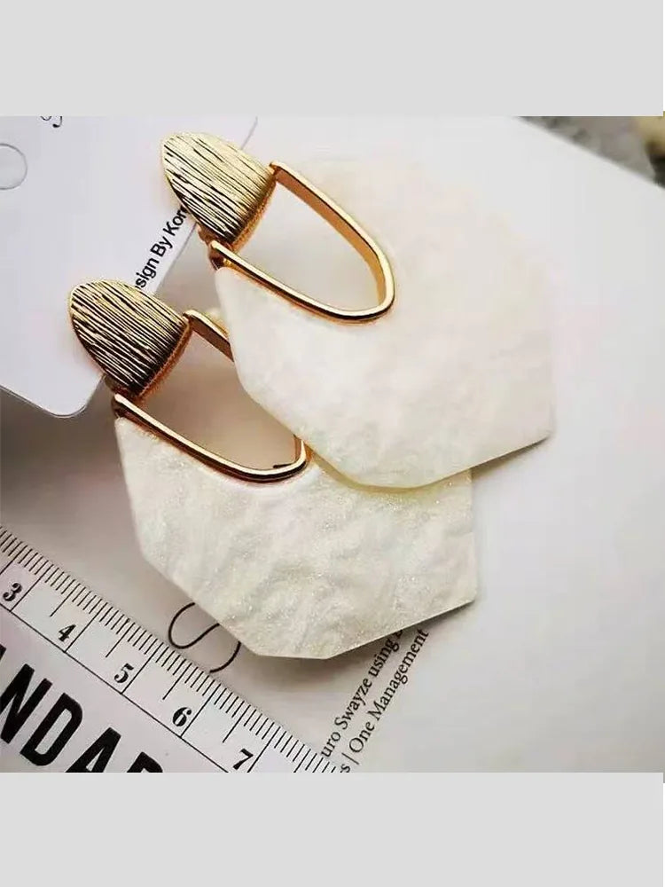 Large earrings in irregular silver and white mica shells