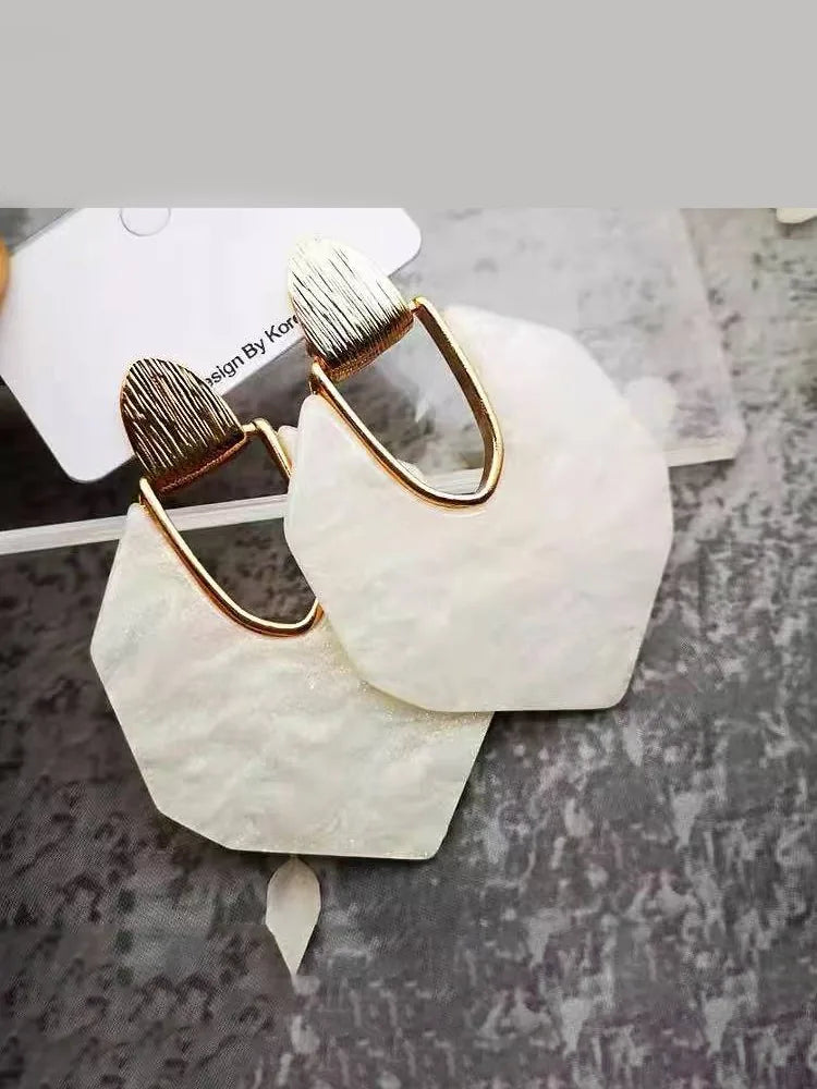 Large earrings in irregular silver and white mica shells