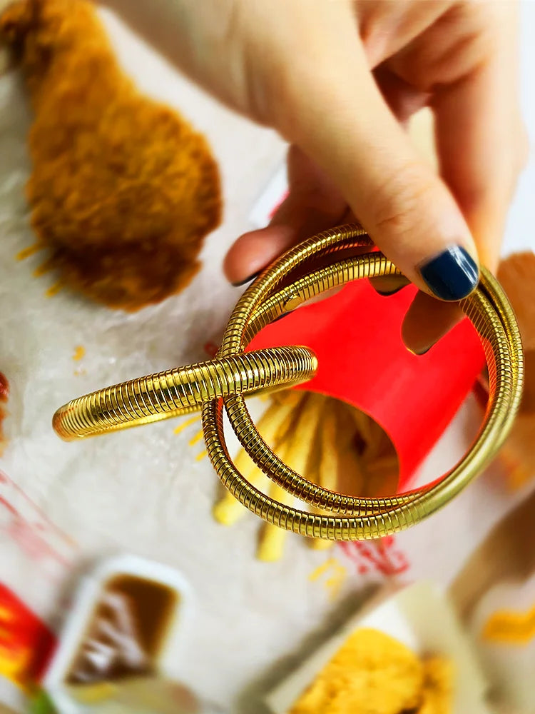 Fairies Whisper Statue of Liberty Bracelet close-up, textured gold metal coil design jewelry