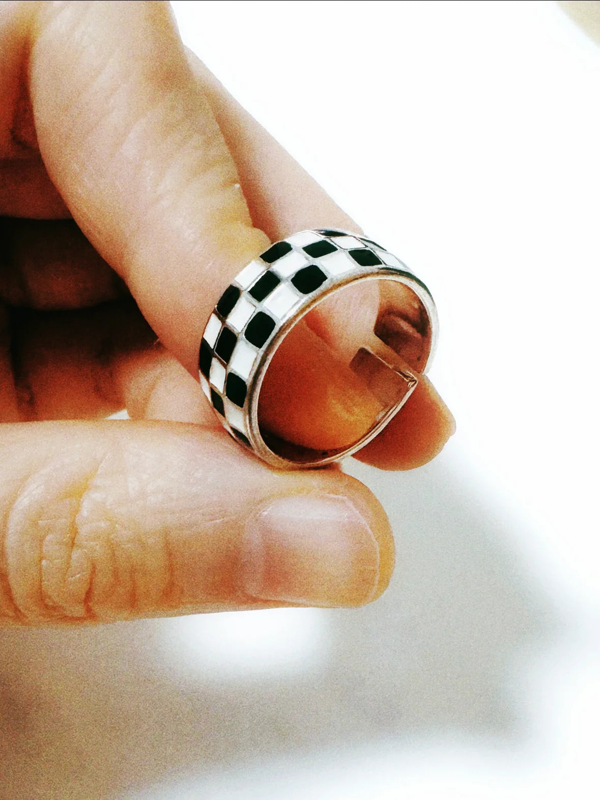 Fairies Whisper Echo Ring close-up, black and white checkerboard pattern statement jewelry