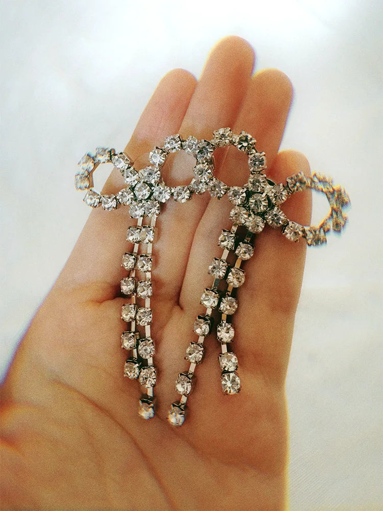 Fairies Whisper Disposable Icons Lustre.AI Bow Earrings worn on ear, elegant jewelry with synthetic diamonds